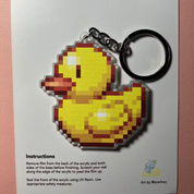 Pixelated duck keychain on a Pixyls branded card with instructions.